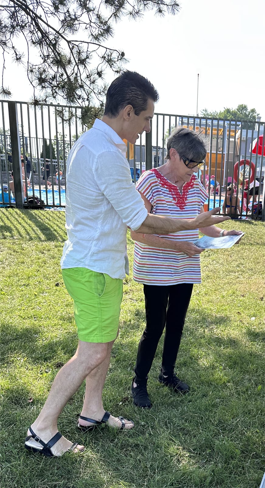 Sinan Erdemir discussing neighbourhood priorities with a resident at a Don Valley East community pool