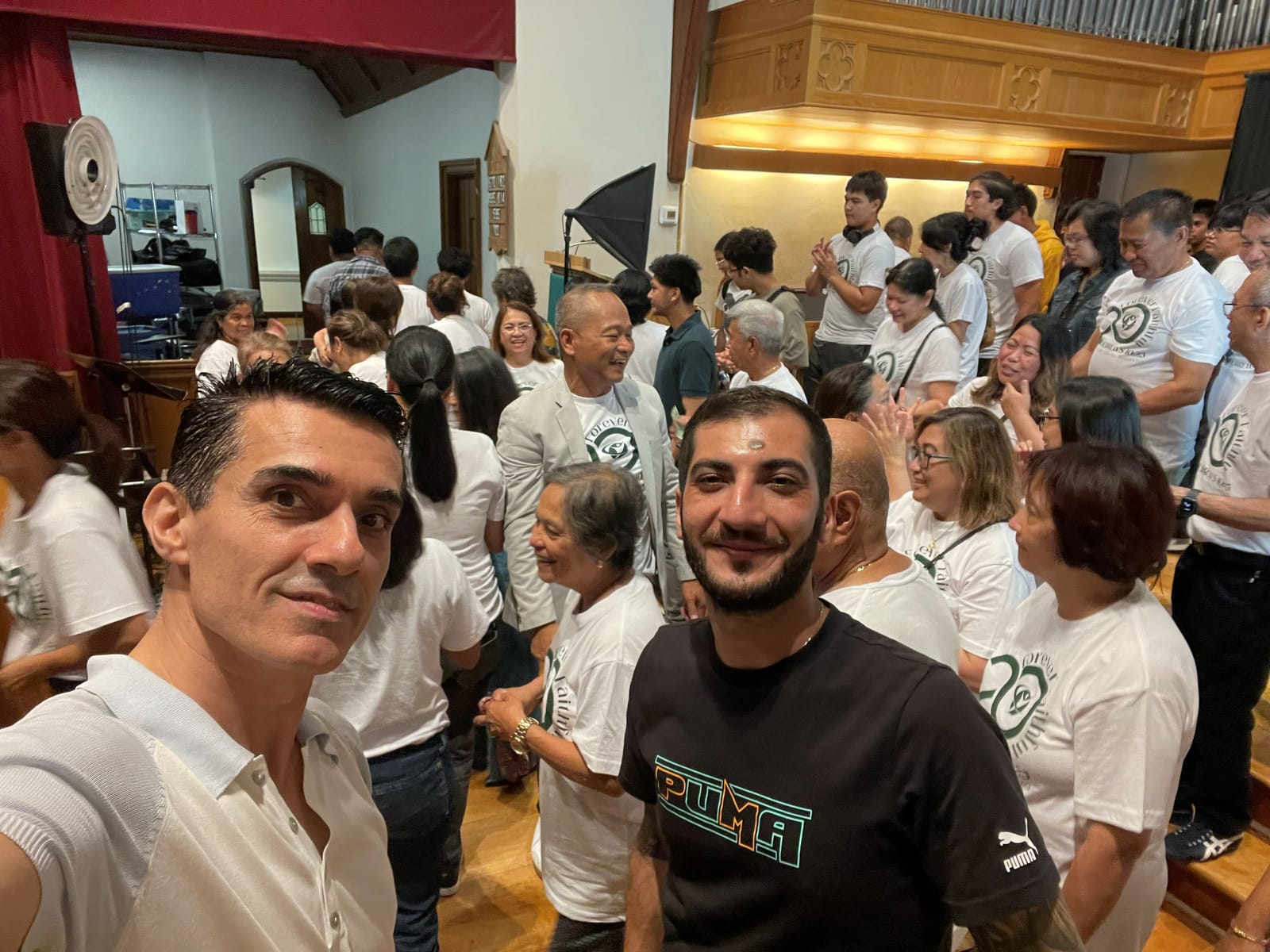 Sinan Erdemir with community members at an indoor cultural celebration in Toronto