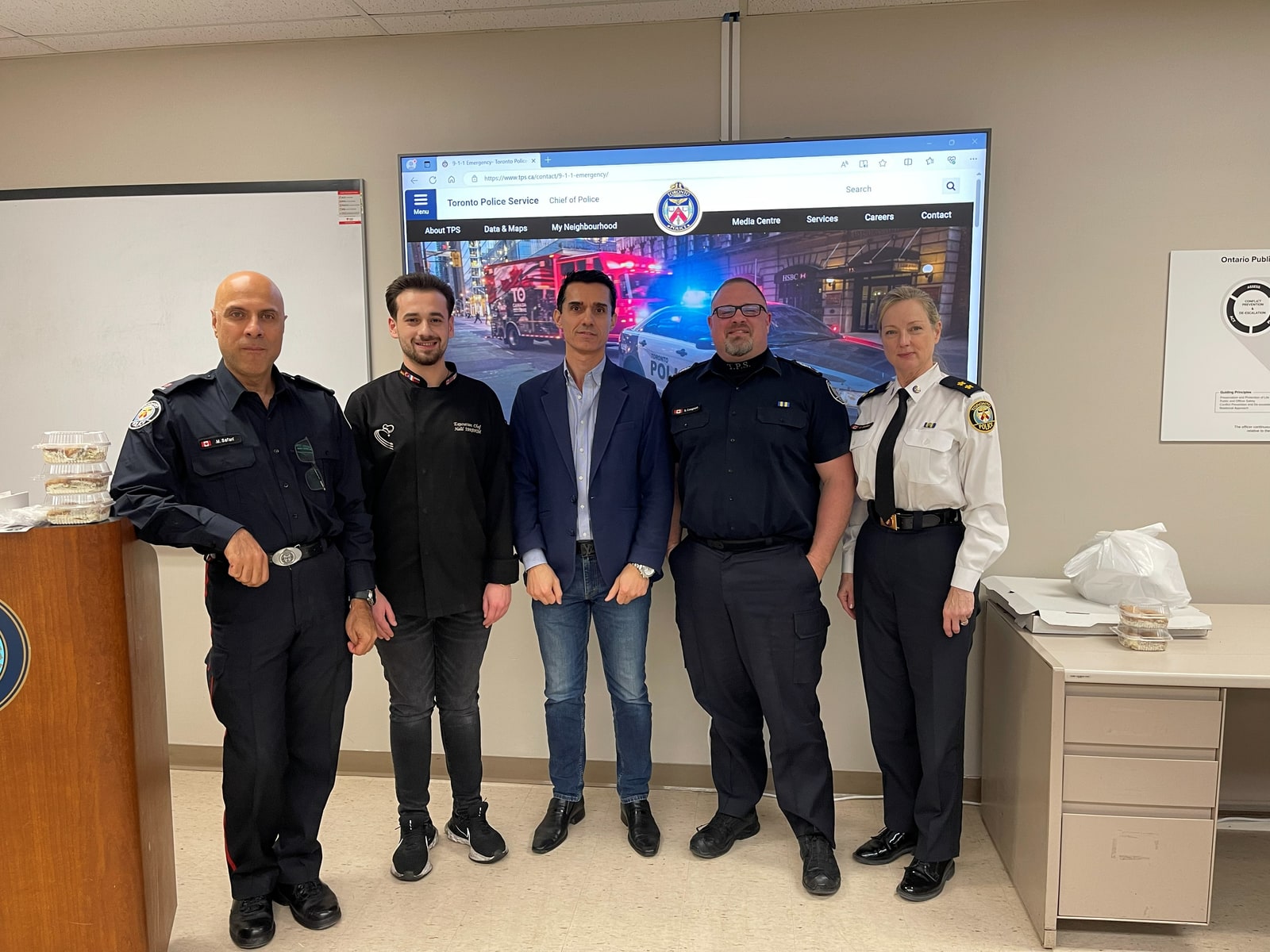 Sinan Erdemir with members of the Toronto Police Service at a 32 Division community meeting